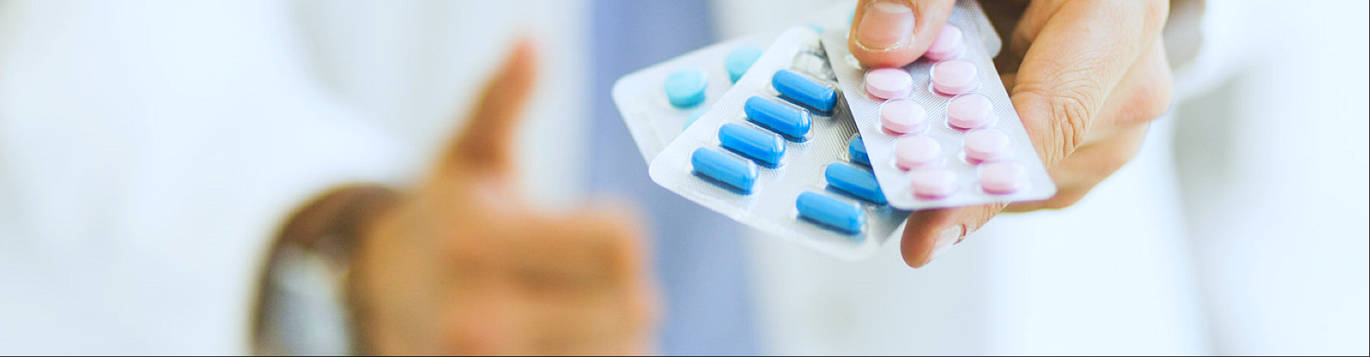 pharmacist holding different kinds of pharmacy products